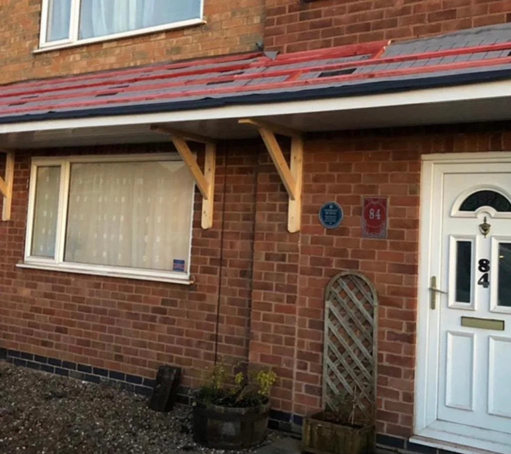 Worn porch canopy roof before re-roofing