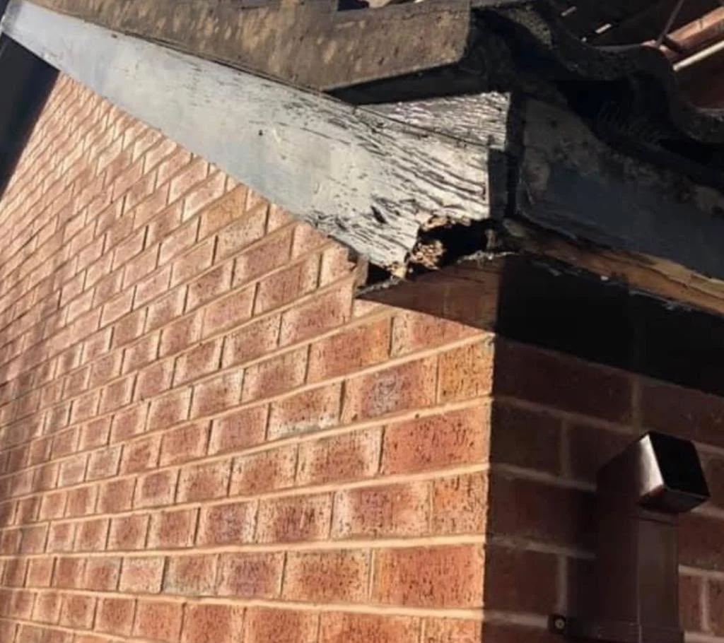 Rotten bargeboard and roof edge before repair